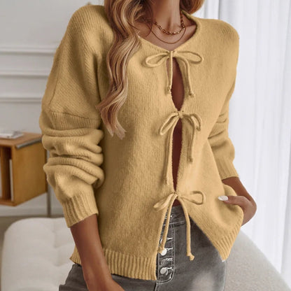 Pink boho knit cardigan with lace-up front detail, relaxed fit, and long sleeves for cozy layering