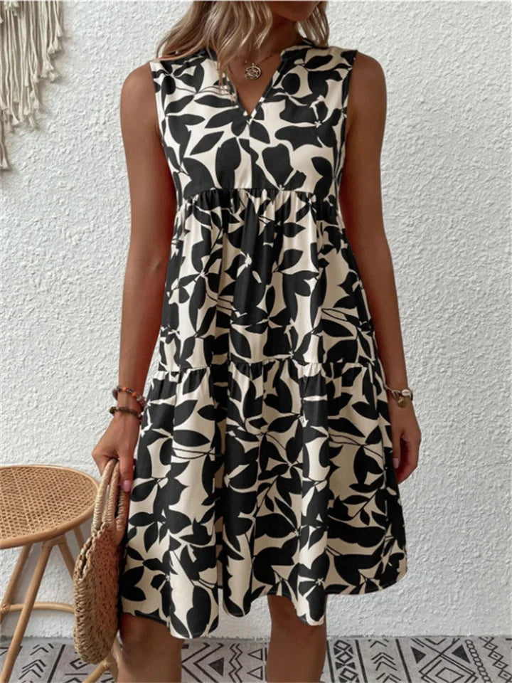 Flowy floral midi dress with elegant drape, waist-defining silhouette, and lightweight summer fabric