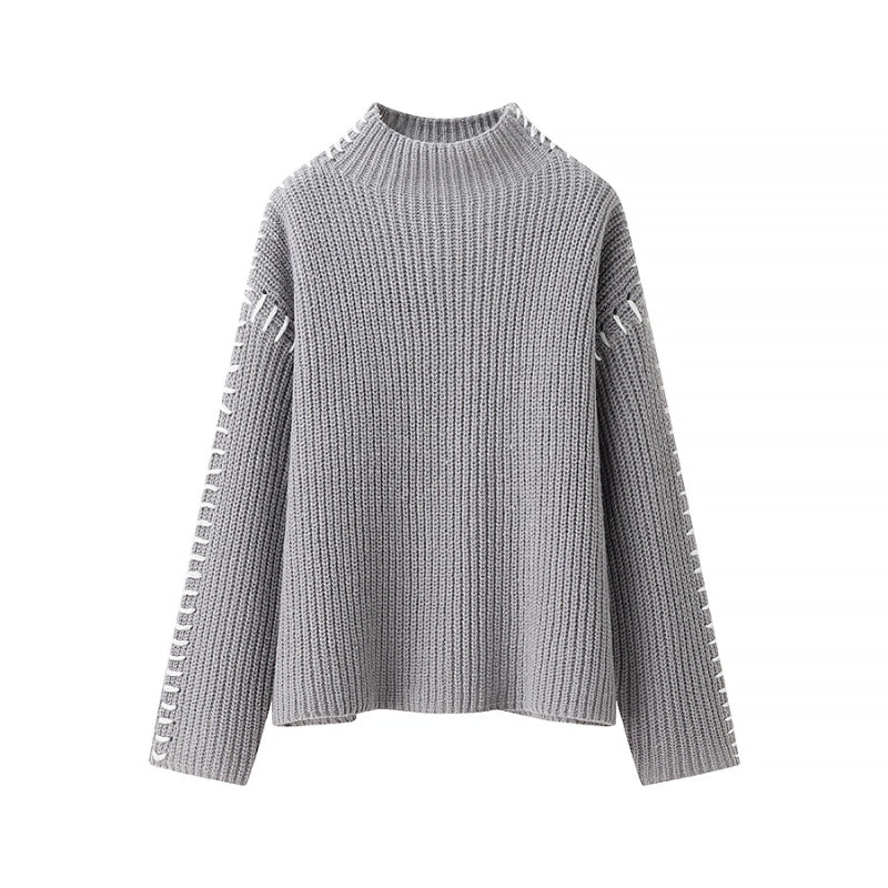 Carmine red soft-knit pullover sweater with relaxed high neck and contrast sleeve stitching