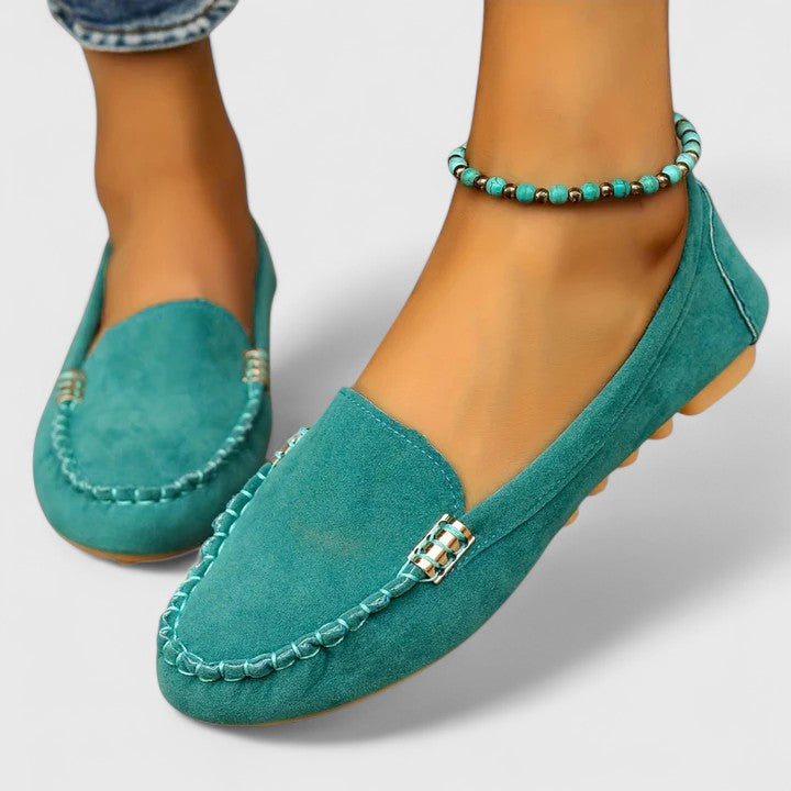 Bold fuchsia suede slip-on loafers with moccasin silhouette and flat sole for women