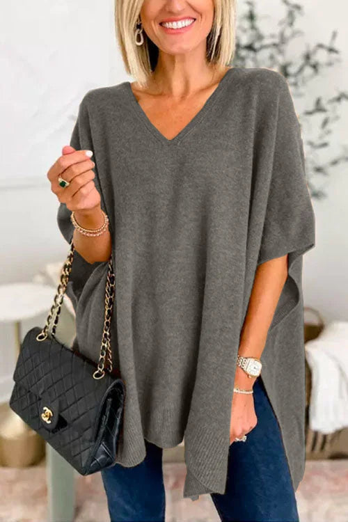 Women's loose-fit soft knit poncho top in neutral tones with V-neck draped design