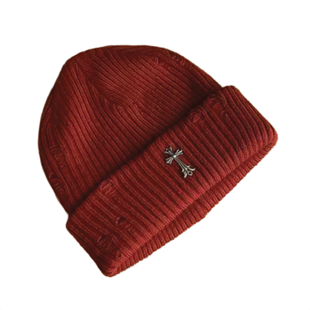 Black ribbed knit beanie with distressed finish and iron cross metal emblem streetwear style