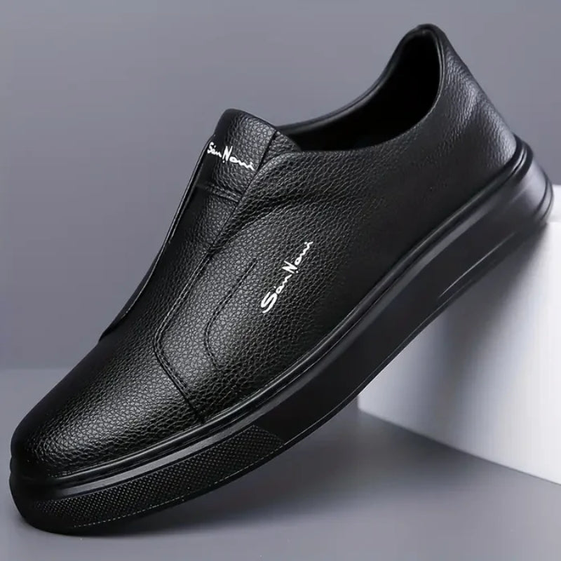 White vegan leather slip-on sneakers with minimalist silhouette and cushioned sole