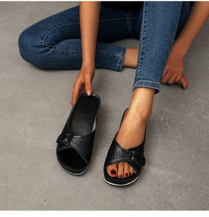 Women's comfort flat sandals in neutral tones with soft footbed cushioning and supportive open-toe silhouette