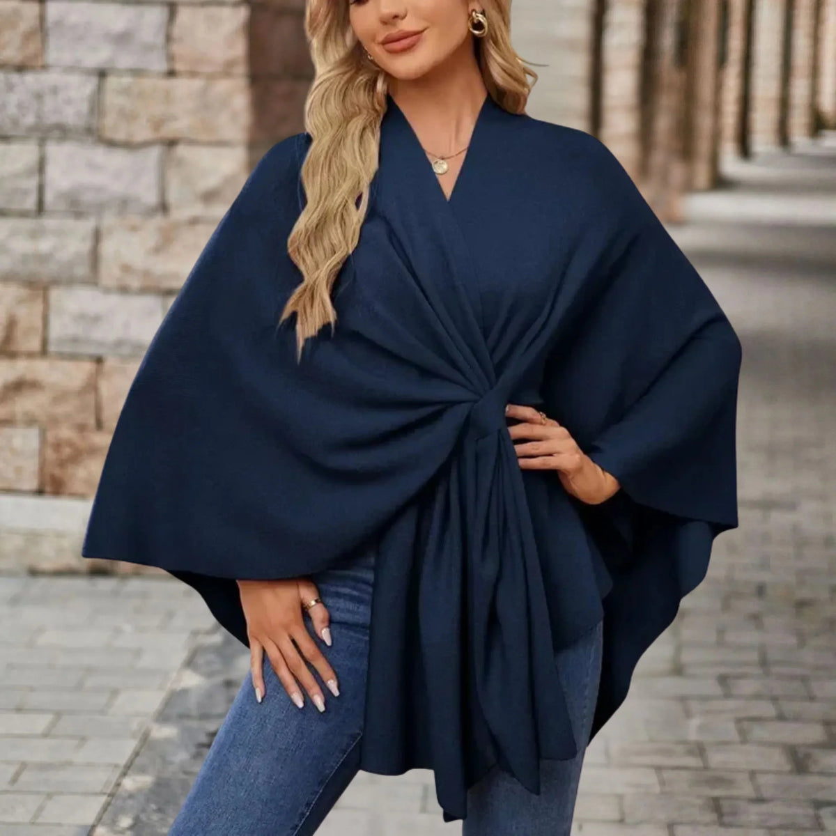 Elegant draped poncho with chic front knot in soft fabric, flowing silhouette for casual or refined style