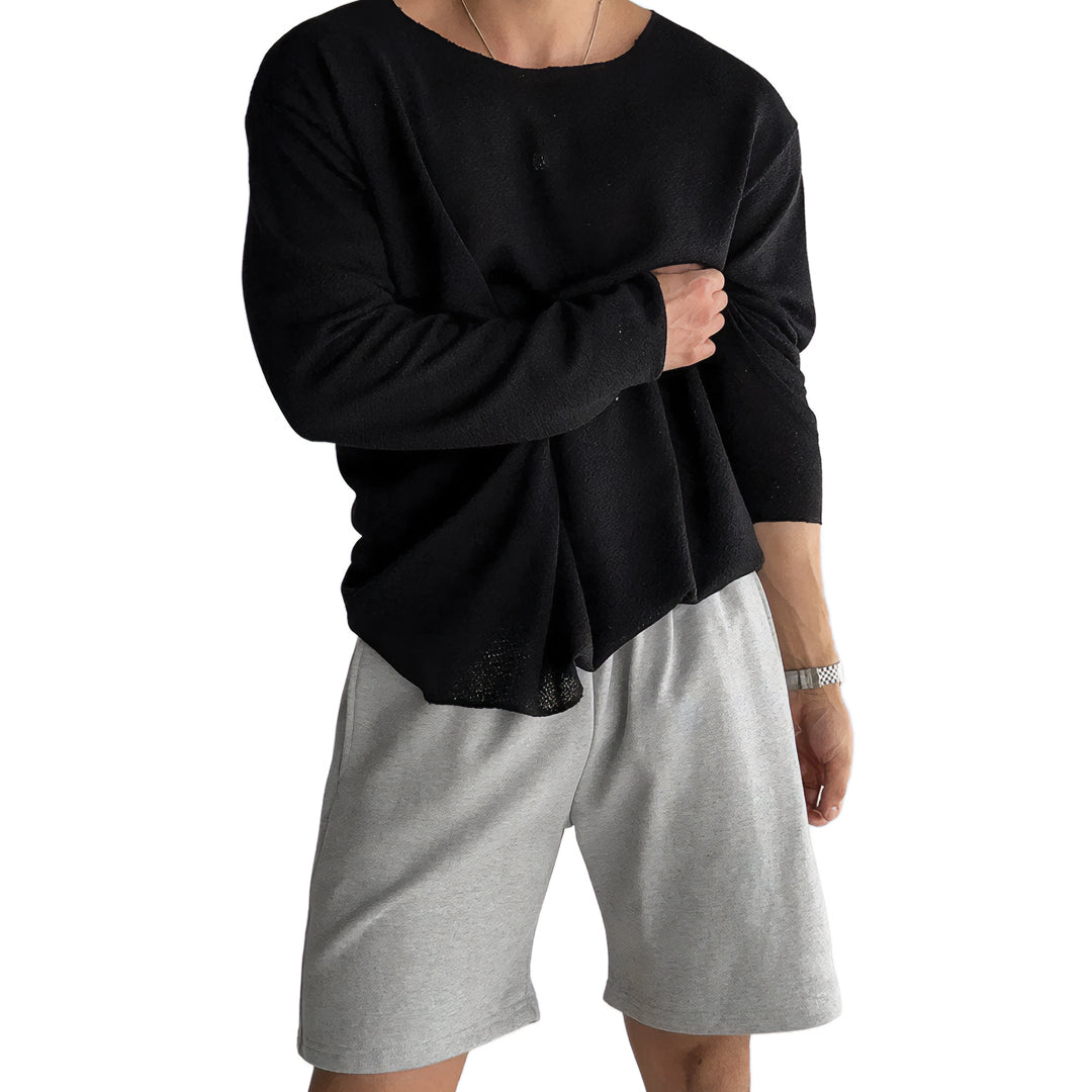 Beige flow knit long sleeve top with relaxed fit, round neck, and lightweight drape