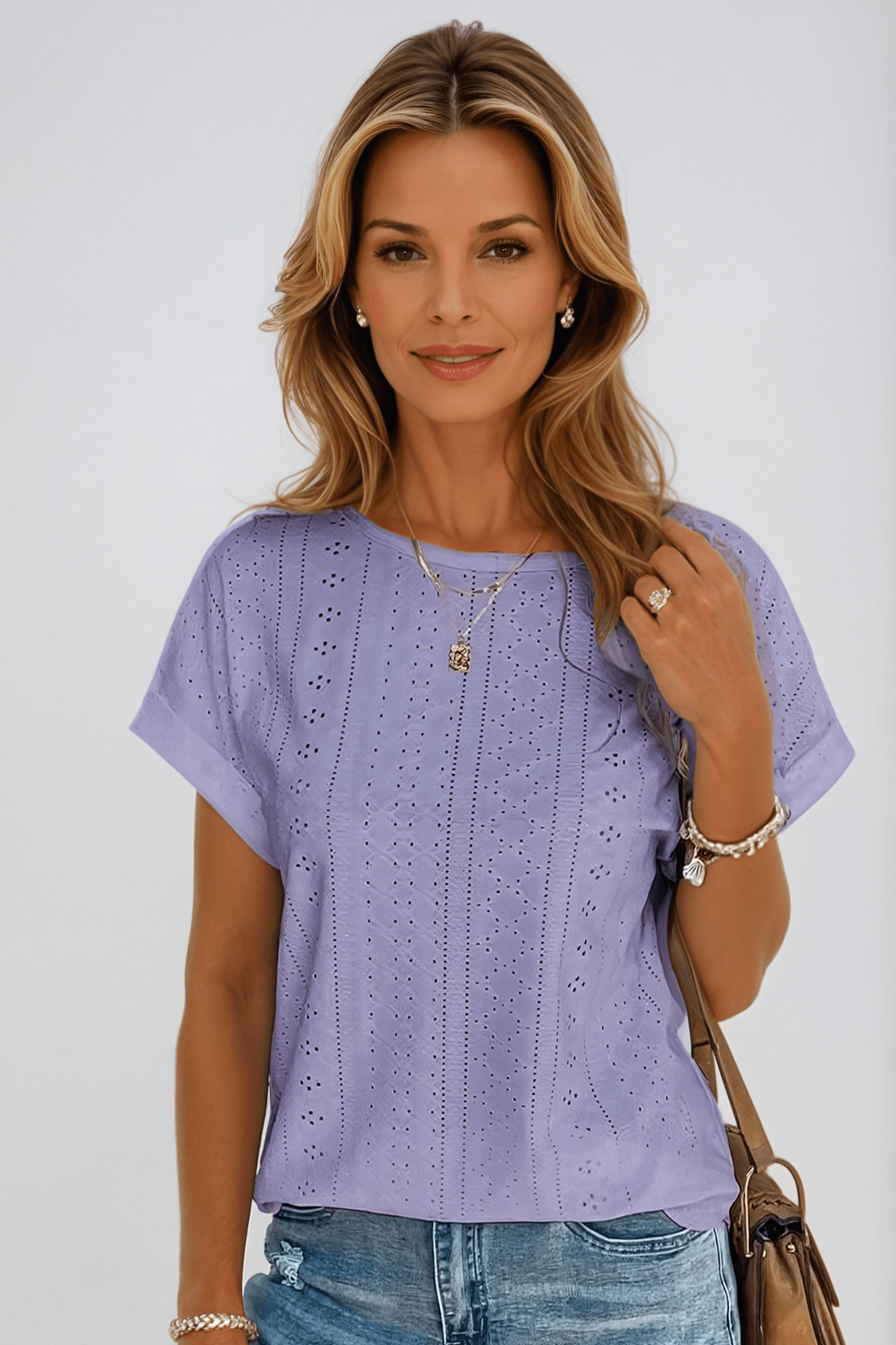 White women's relaxed crew neck short sleeve top with all-over vertical eyelet embroidery detail