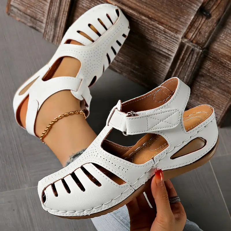 Women's minimalist sandals in neutral tone with cushioned sole and sleek silhouette for all-day comfort