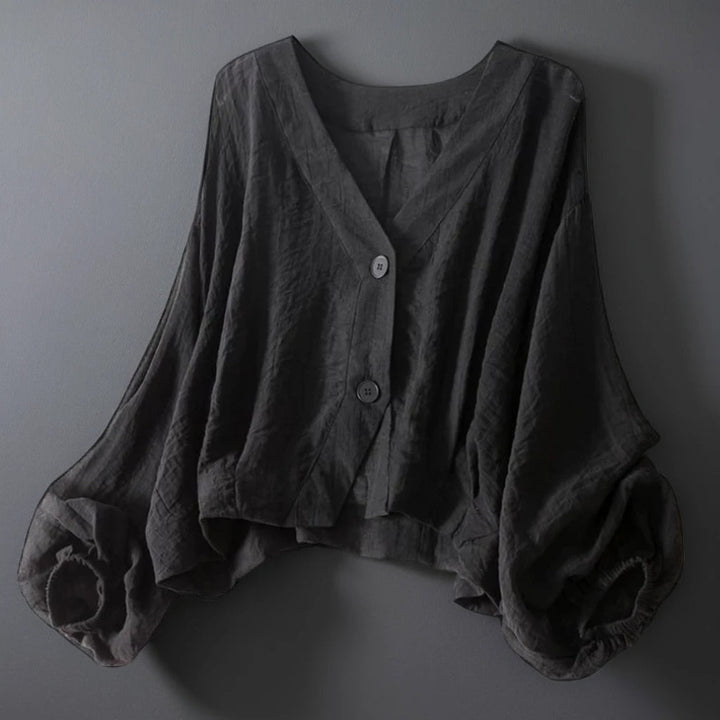 Women's white crinkled linen blouse with voluminous balloon sleeves and button front closure