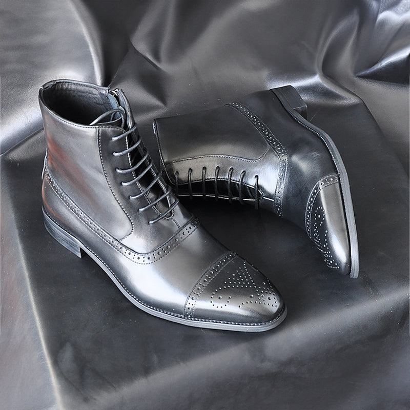 Dark brown lace-up leather boots with brogue cap toe detail and side zipper