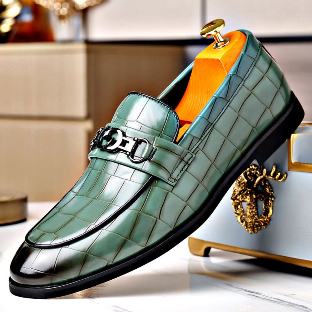 Men's textured leather loafers with polished finish and sleek metal buckle accent for formal wear