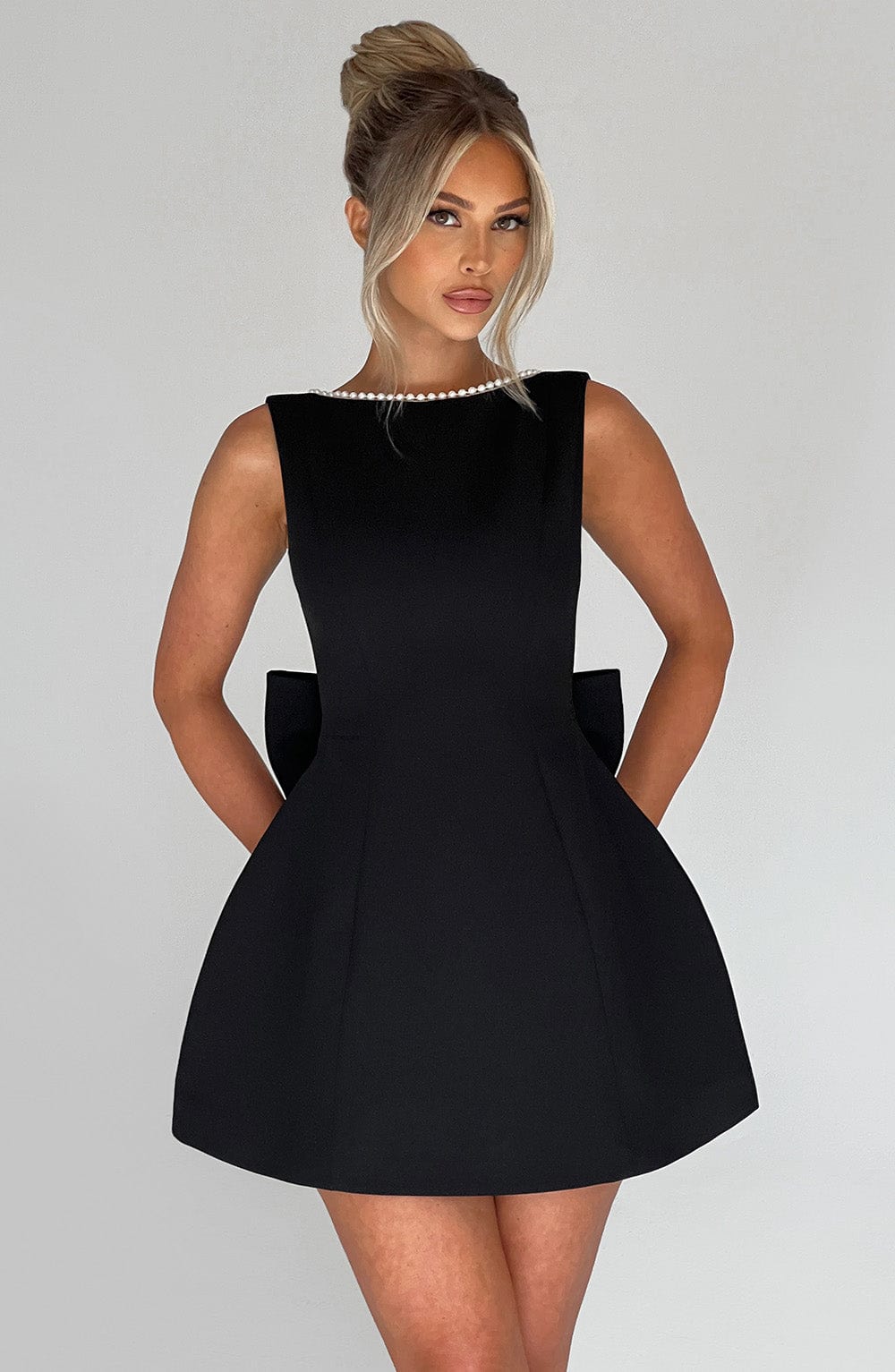 White sleeveless A-line mini dress with delicate pearl trim detailing for women