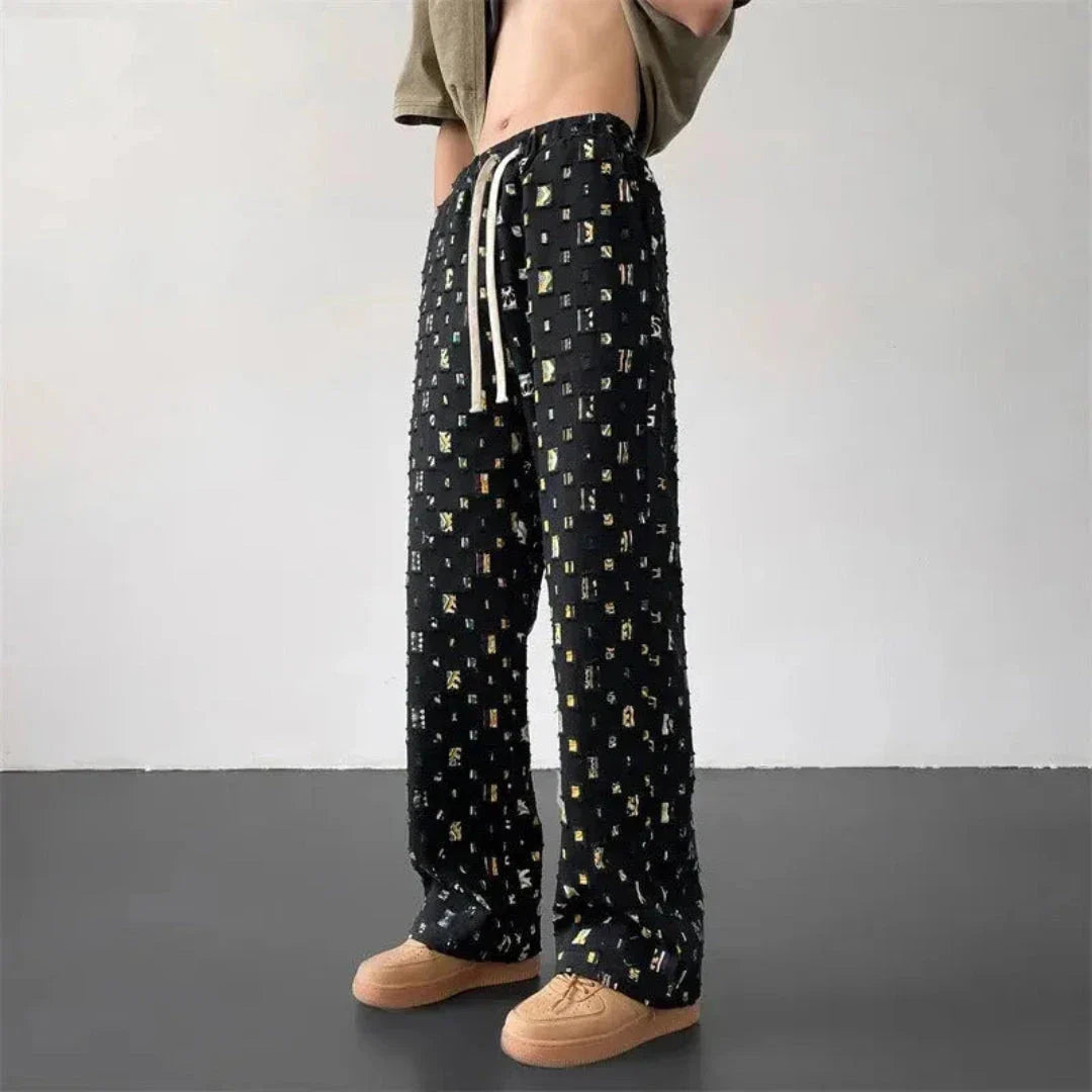 Men's multicolor geometric patchwork pants with 3D square cut-out grid design and drawstring waist