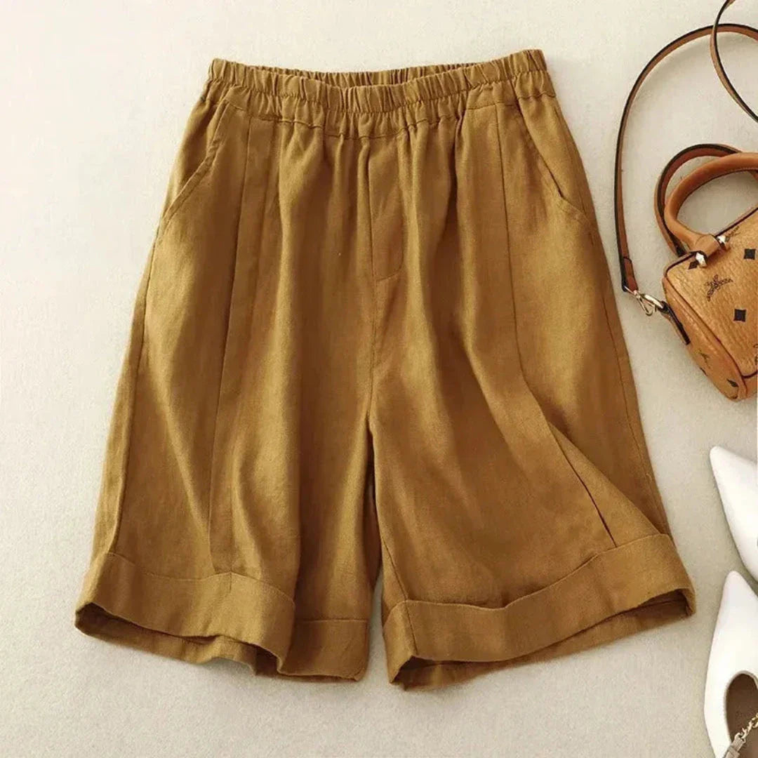 Beige high-rise linen blend shorts with rolled cuffed hem and elastic waistband for warm weather