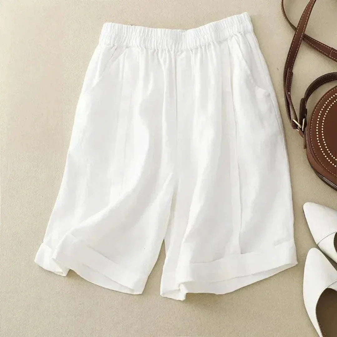 Women's beige high-rise linen shorts with rolled cuffed hem and elastic waistband for warm weather