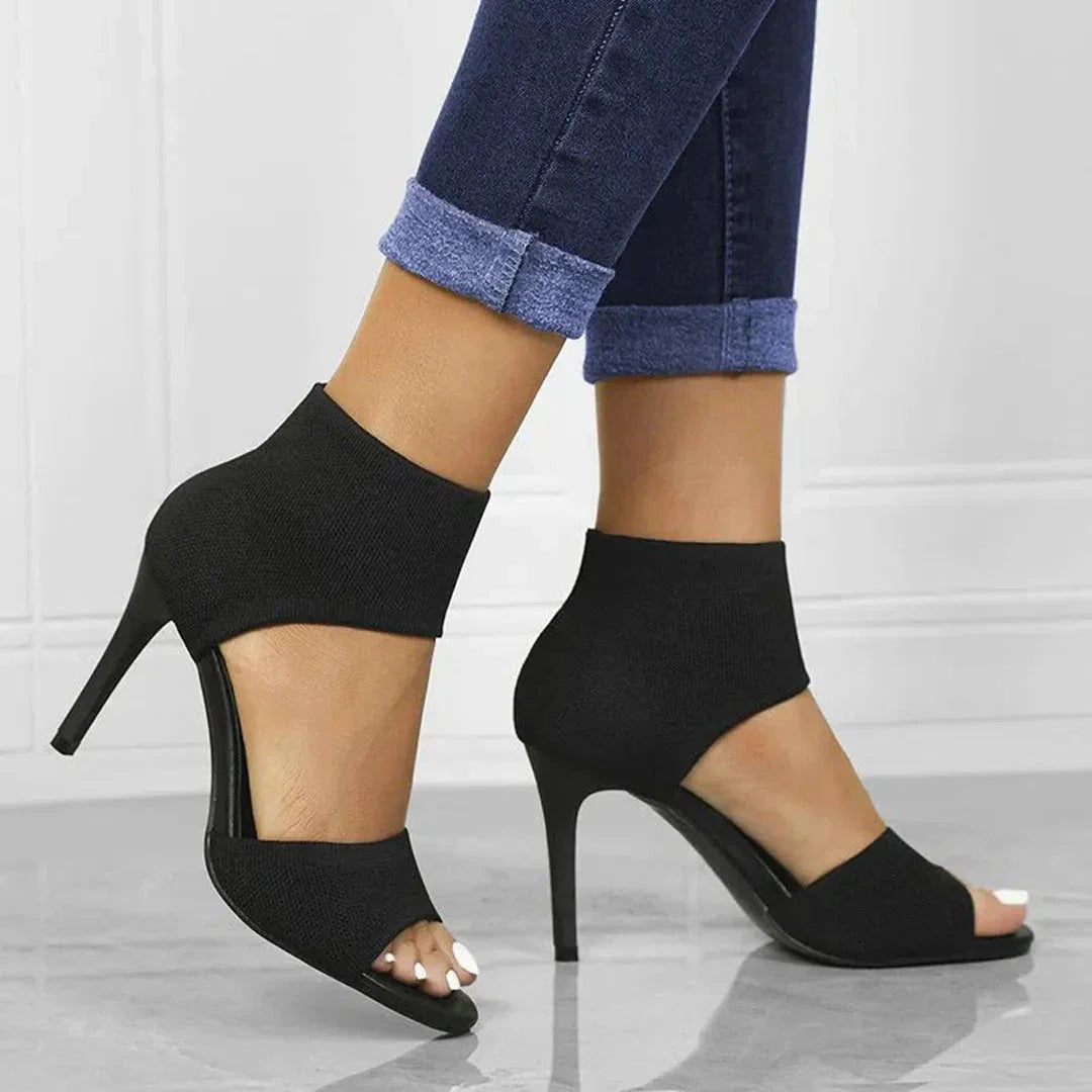 Women's black stretch-knit stiletto sandals with open-toe design and slim high heel ankle cuff