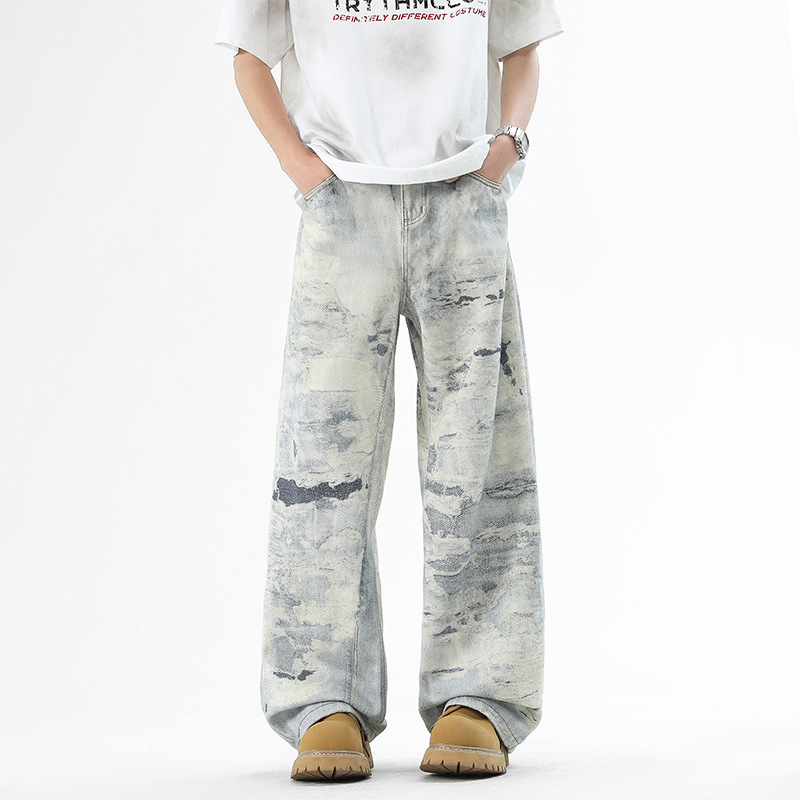 Blue wide-leg denim jeans with vivid all-over paint-splatter print for urban street style