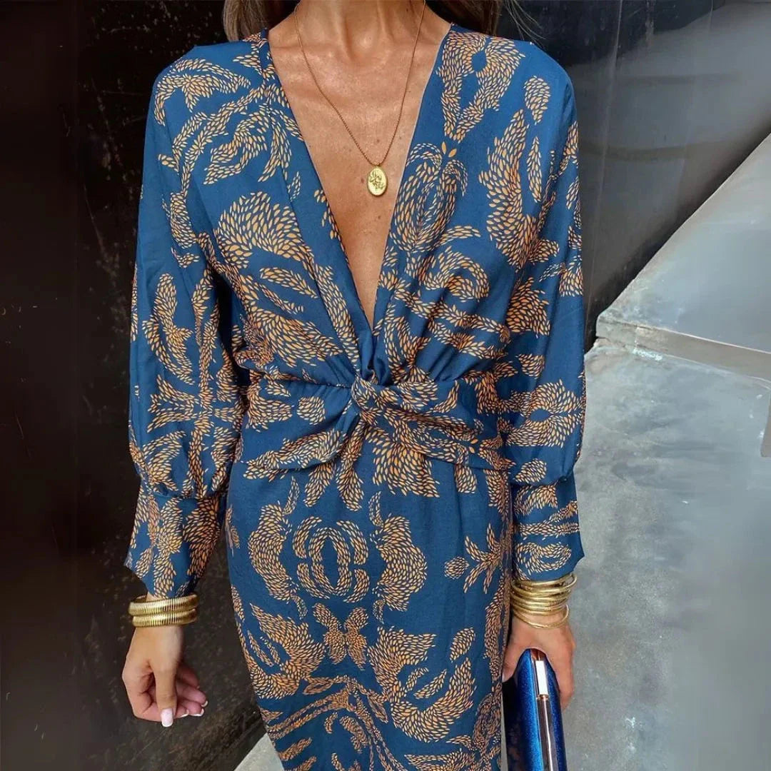 Flowy bohemian maxi dress with twist-front waist detail in warm-toned fabric for resort wear