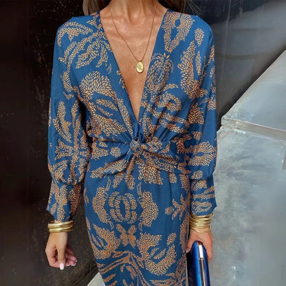 Flowy bohemian maxi dress with twist-front waist detail in warm-toned fabric for resort wear