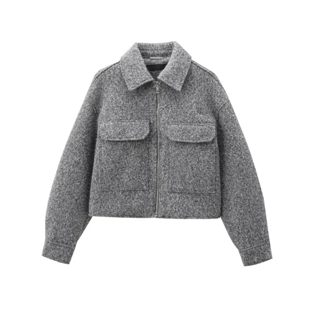 Cropped wool blend zip-up jacket in neutral tone with structured silhouette and dual utility pockets