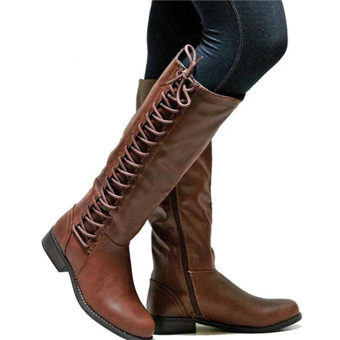 Women's black faux leather knee-high boots with lace-up front detail and flat sole side zipper