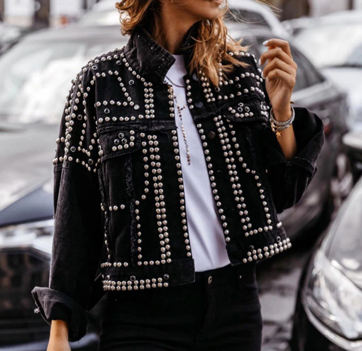 Women's black cropped jacket with all-over silver metallic studs, bold hardware streetwear style