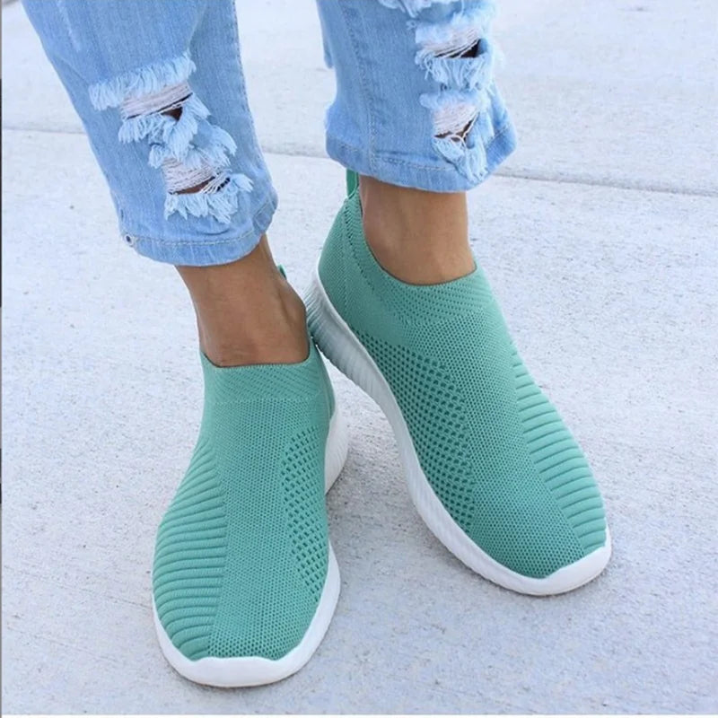 Women's white breathable slip-on sneakers with sock-like knit upper and lightweight flexible sole