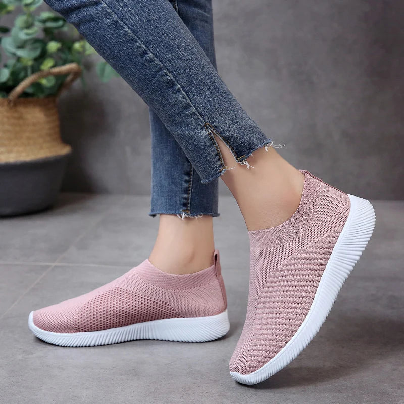 Women's white breathable slip-on sneakers with knit upper, lightweight sole, sock-like fit