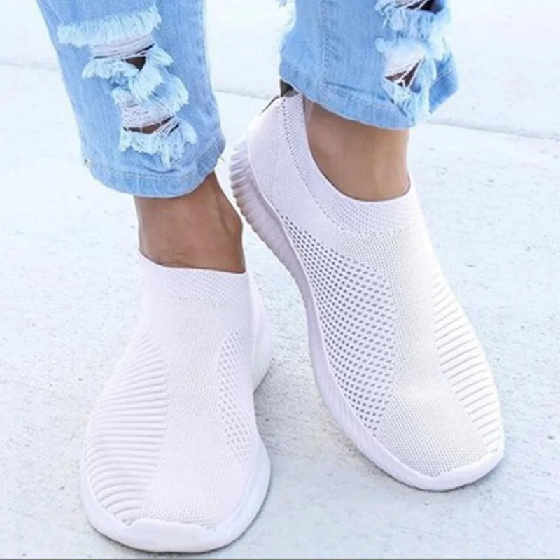 Women's white breathable slip-on knit sneakers with lightweight rubber sole and sock-like fit