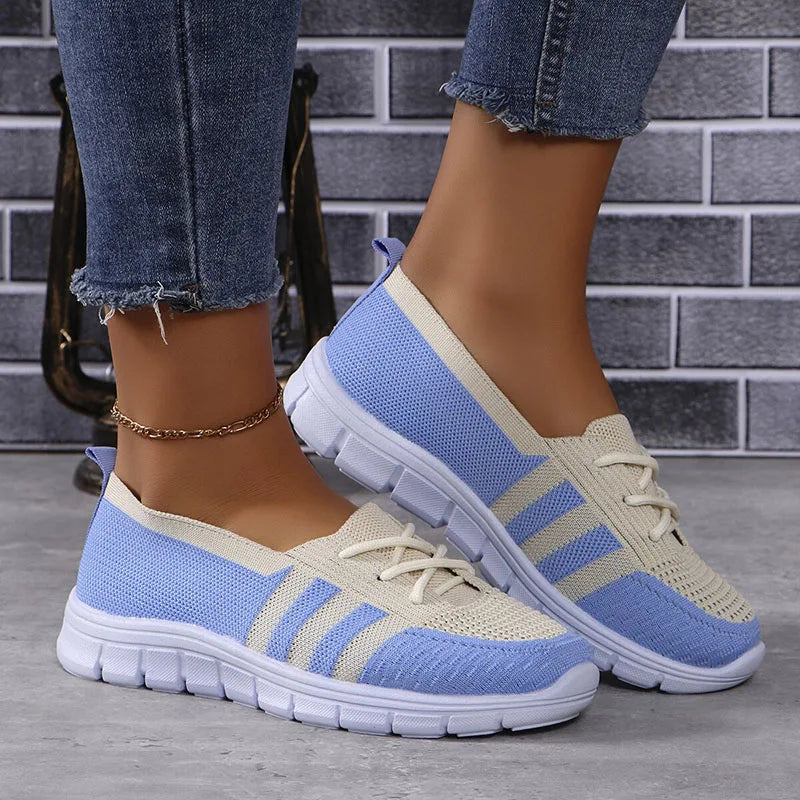 Women's white breathable slip-on sneakers with lightweight knit upper and casual stylish design