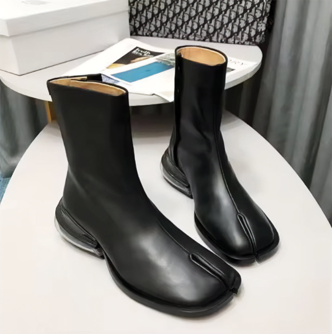 Black vegan leather split-toe tabi boot with air-cushioned heel and bold fashion-forward silhouette