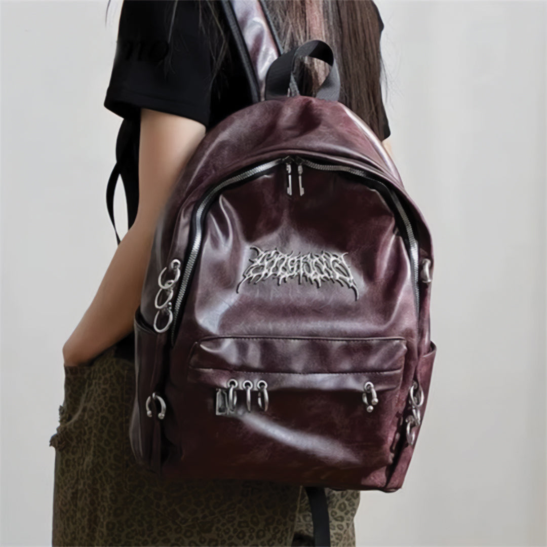 Wavlynn Rebel Chrome vegan leather backpack with metallic circle accents and secure zipper closures for urban style