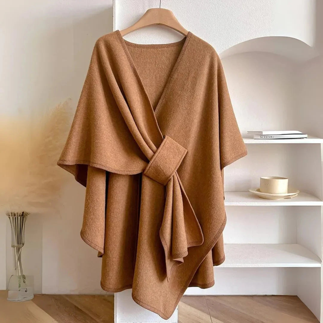 Beige loose knitted fleece cape shawl with waist-cinching hook and draped shoulder silhouette