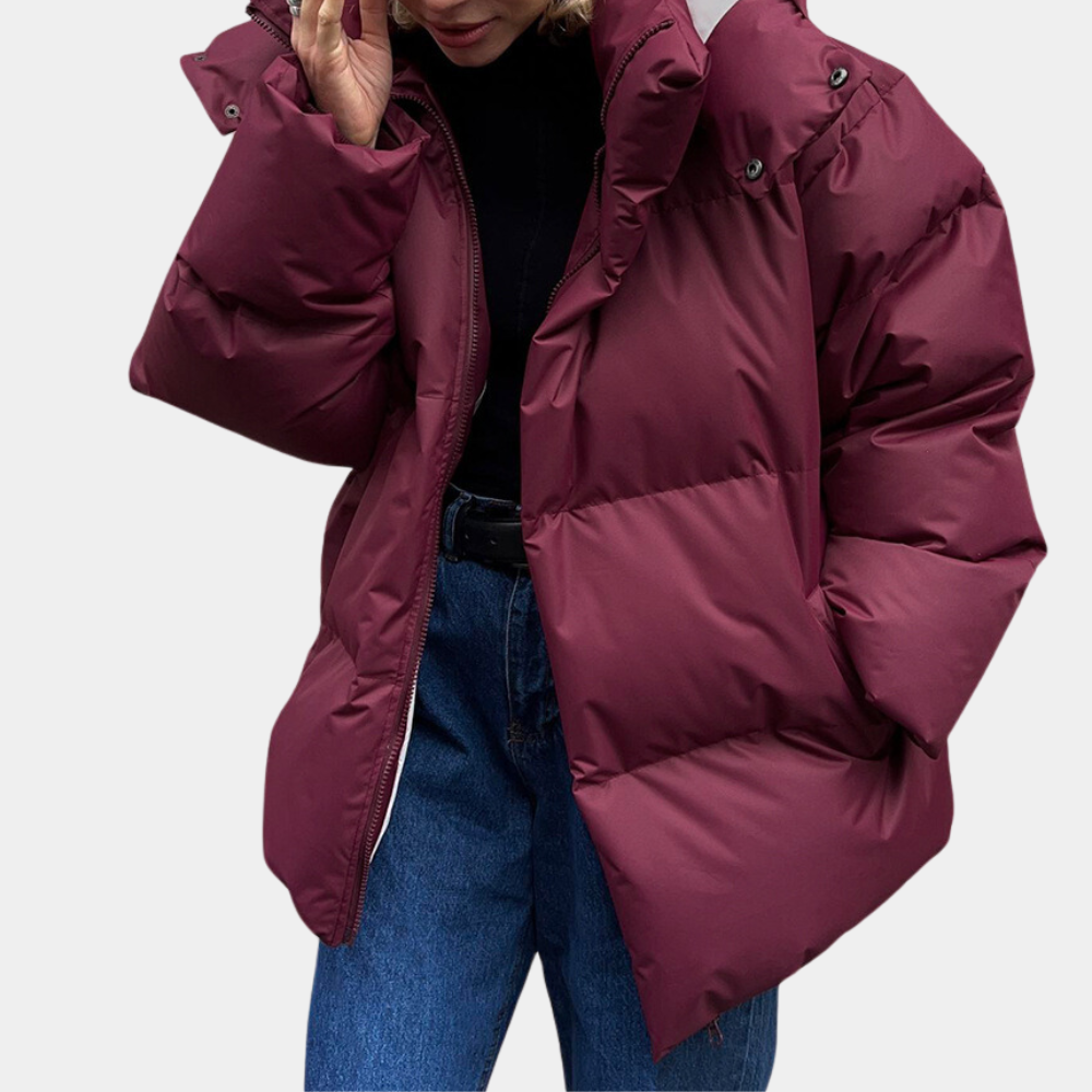 Women's oversized quilted puffer jacket with hood, water-repellent design in neutral tones for cold weather