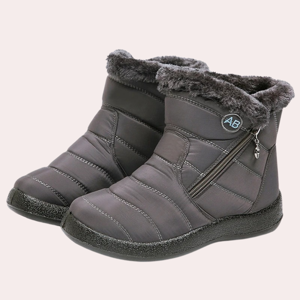 Women's black quilted boots with faux fur lining, side zipper, and non-slip winter sole