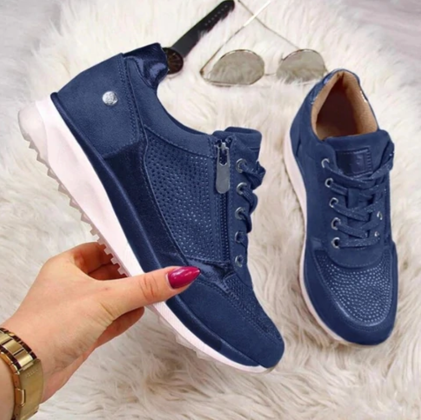 Women's low-top fashion sneaker in metallic finish with rhinestone embellishments and lace-up zip detail