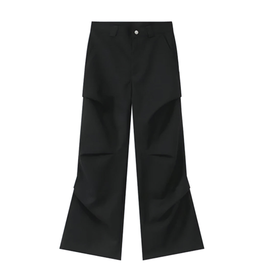 Beige loose-fit wide-leg cotton trousers with button fly and subtle fold detailing