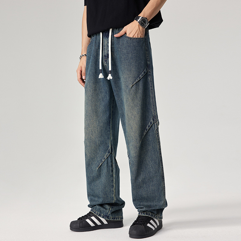 Caulfield blue denim joggers relaxed fit with distressed wash and angular seam detailing