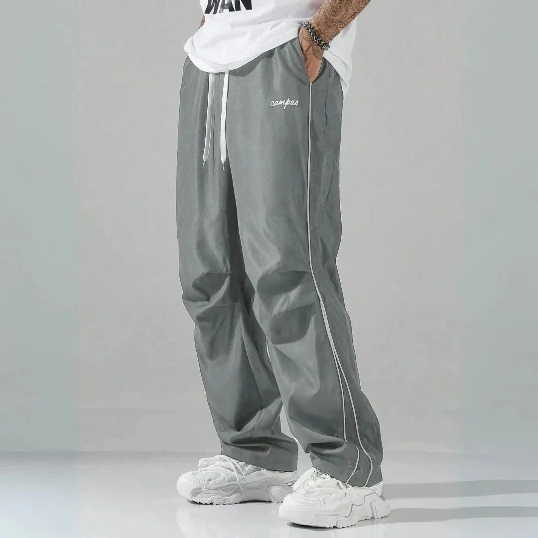 Charlie relaxed-fit track pants with contrast side piping and embroidered campus logo streetwear style