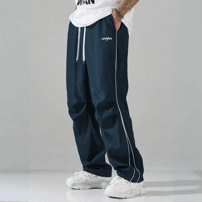 Charlie relaxed-fit track pants with contrast side piping and embroidered campus logo streetwear style