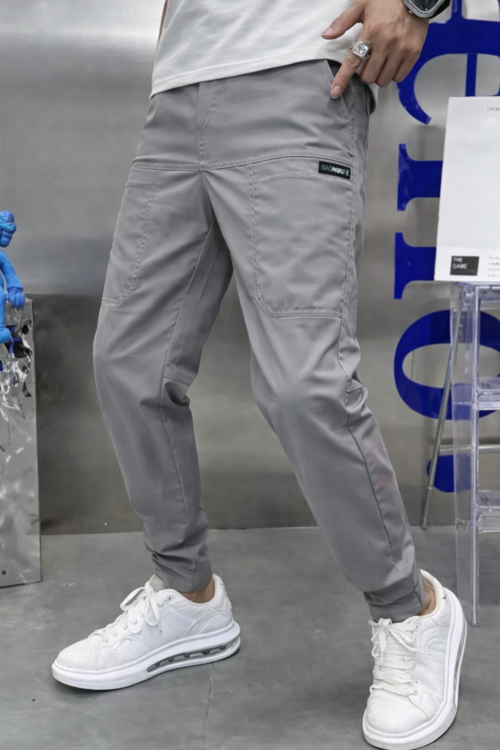 Men's stretch cargo pants in neutral tone, slim modern cut with multi-pocket utility design