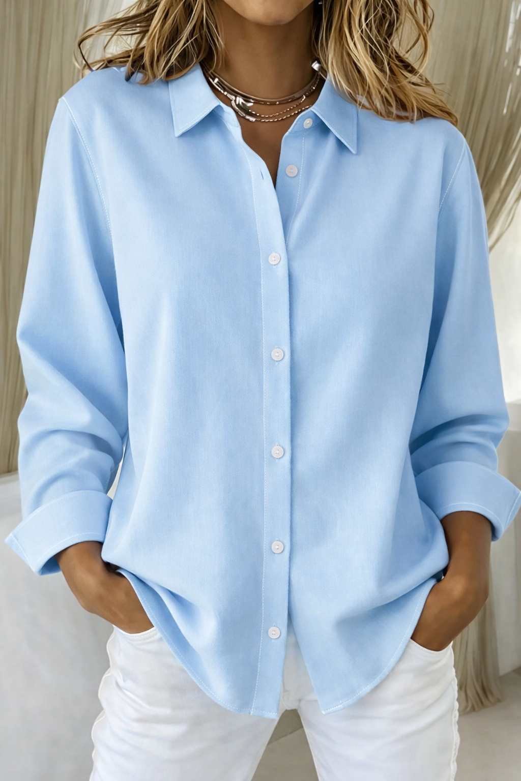 Elegant white button-down blouse with structured collar and classic refined silhouette