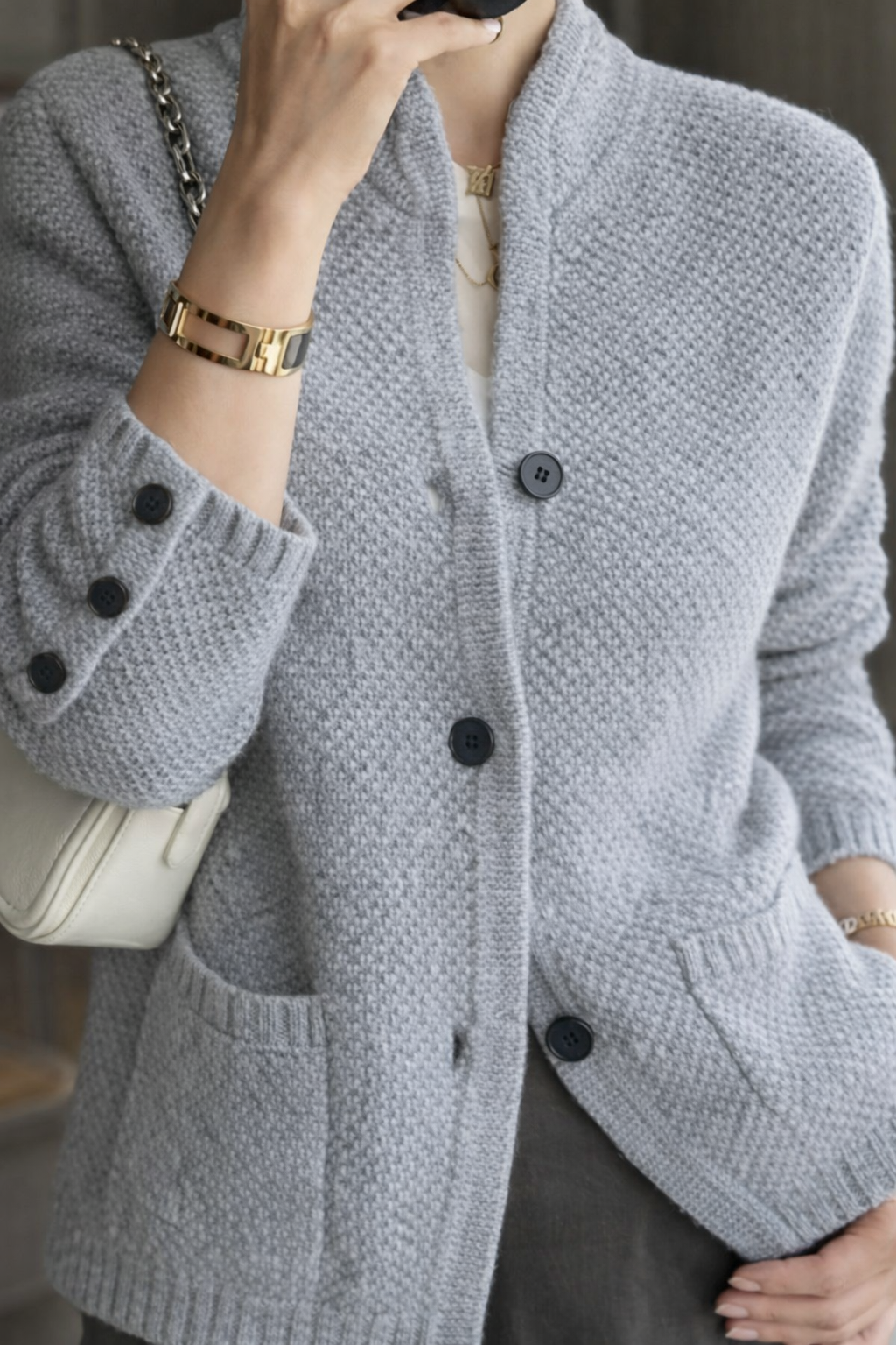 Elegant cream button-down cardigan with classic silhouette and refined detailing for polished everyday style