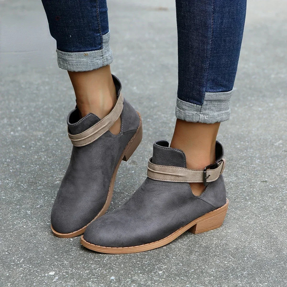 Women's black chic ankle boots with adjustable buckle strap, elegant silhouette for versatile wear
