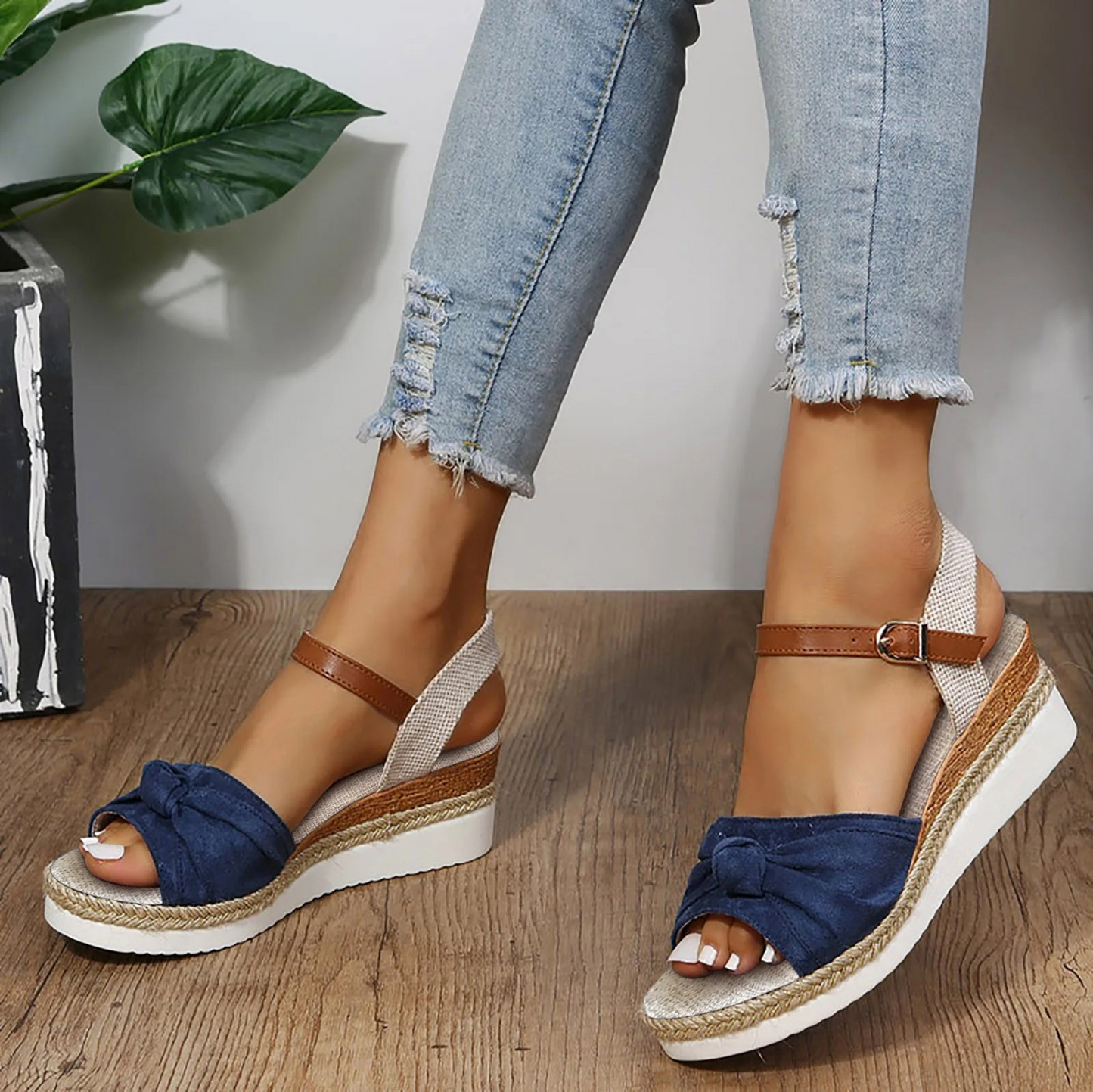 Women's closed toe wedge sandals in neutral tone with elegant knot detail and adjustable ankle strap