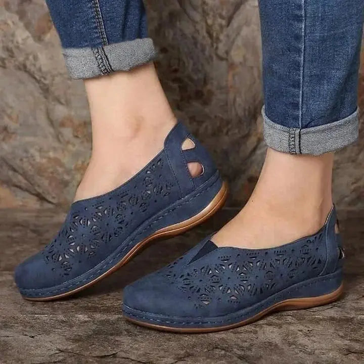 Women's beige low wedge slip-on shoes with chic floral cut-out perforations for breathable style