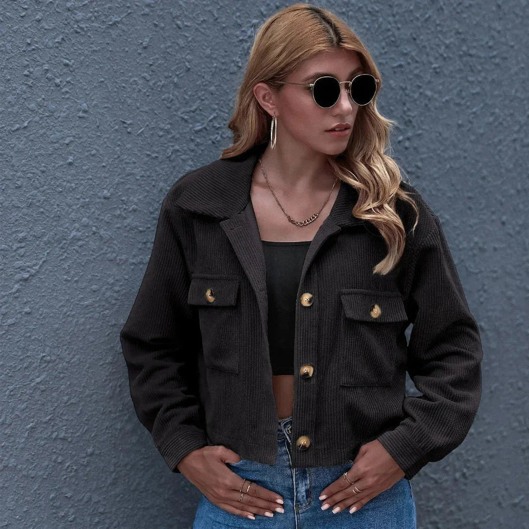 Cropped corduroy jacket in neutral tone with oversized fit, collared neckline, and vintage-inspired cotton blend
