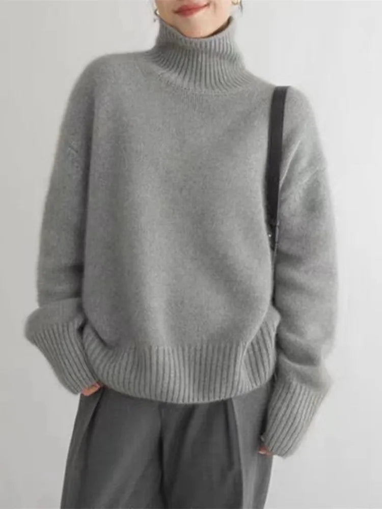 Oversized cream turtleneck sweater with ribbed details and drop shoulders for cozy winter style
