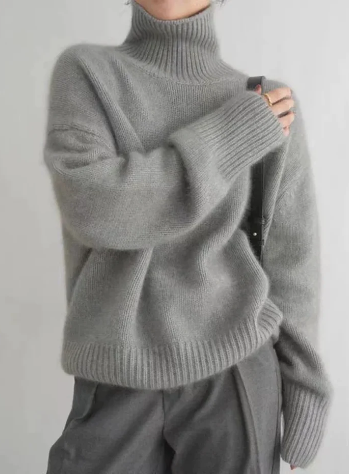 Soft ivory turtleneck sweater with timeless silhouette and luxurious cozy knit fabric