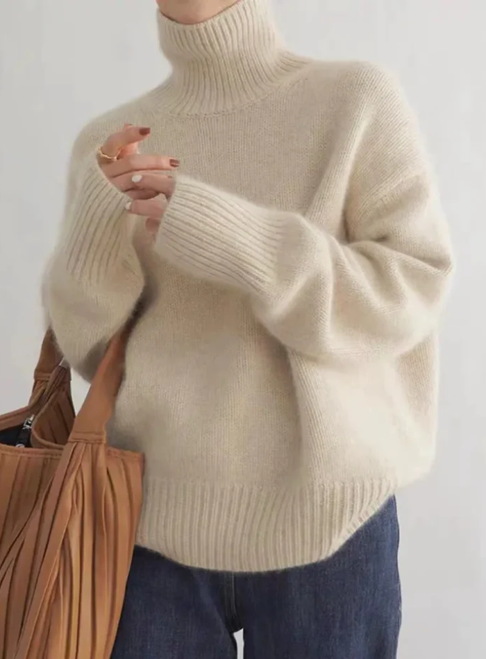 Soft ivory turtleneck sweater with timeless silhouette and luxurious cozy knit fabric